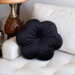 black flower pillow on a sofa