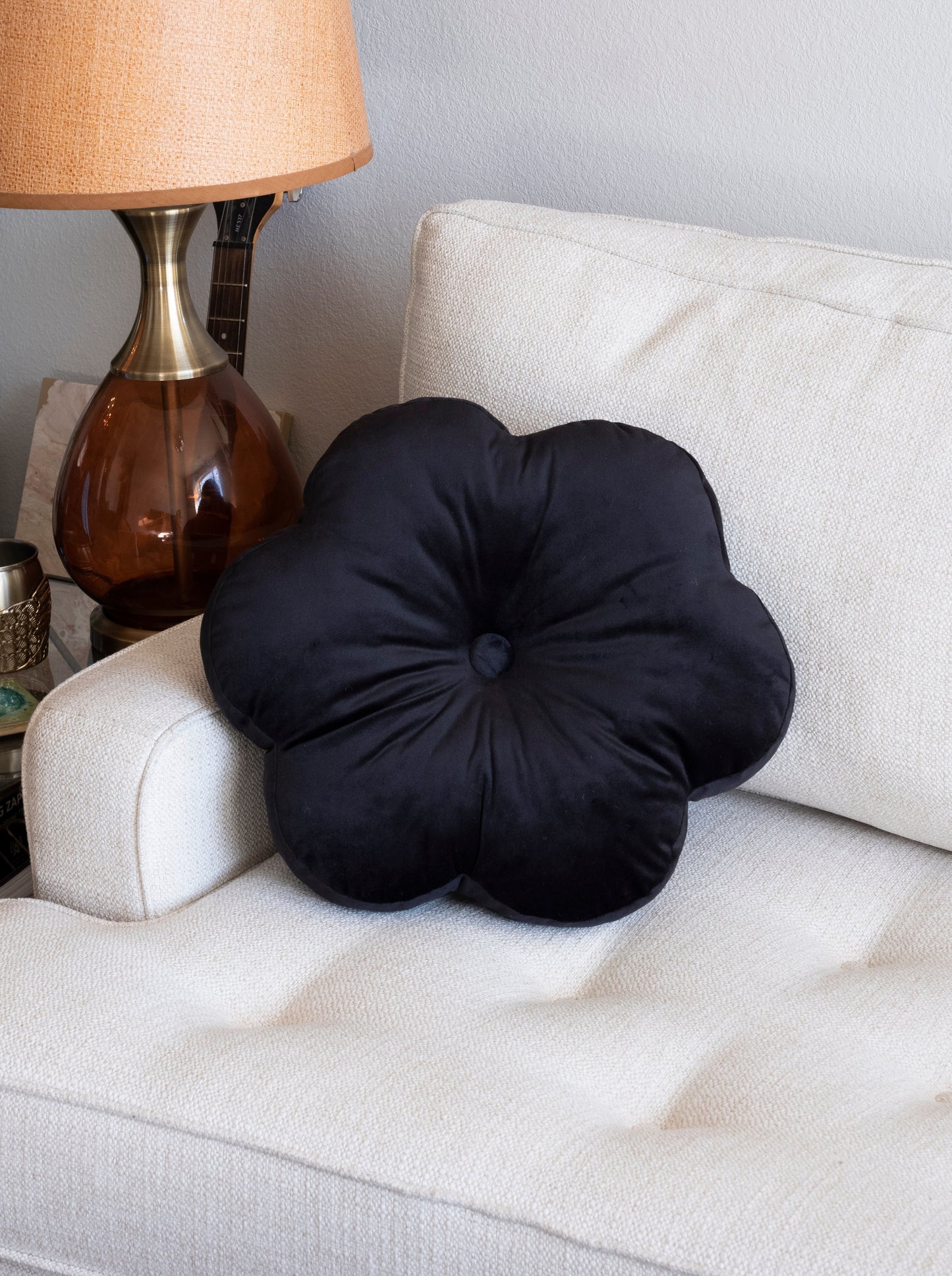 black flower pillow on a sofa