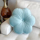 light blue flower pillow on a sofa