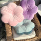 light pink, purple, and light blue flower pillows