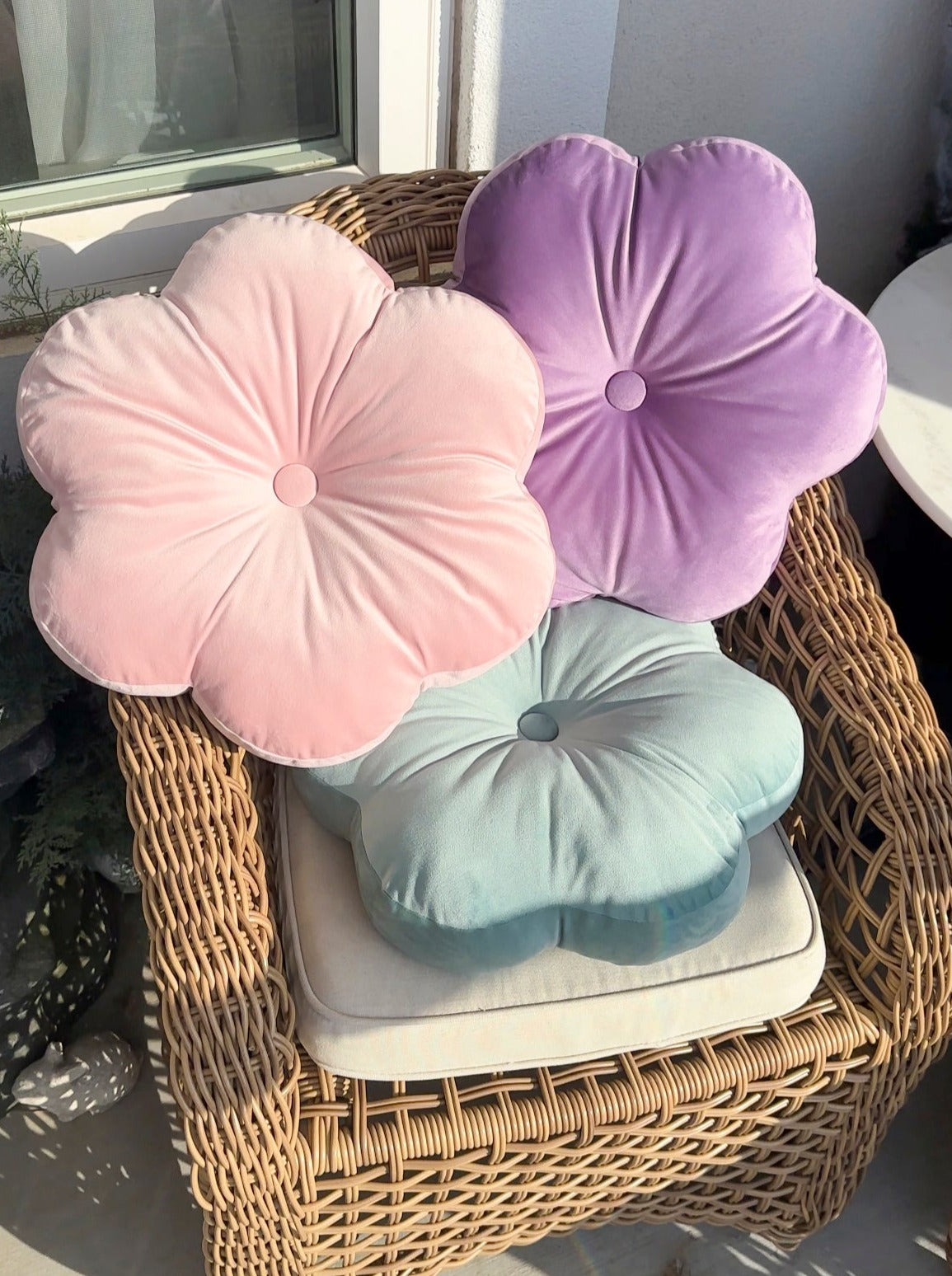 light pink, purple, and light blue flower pillows